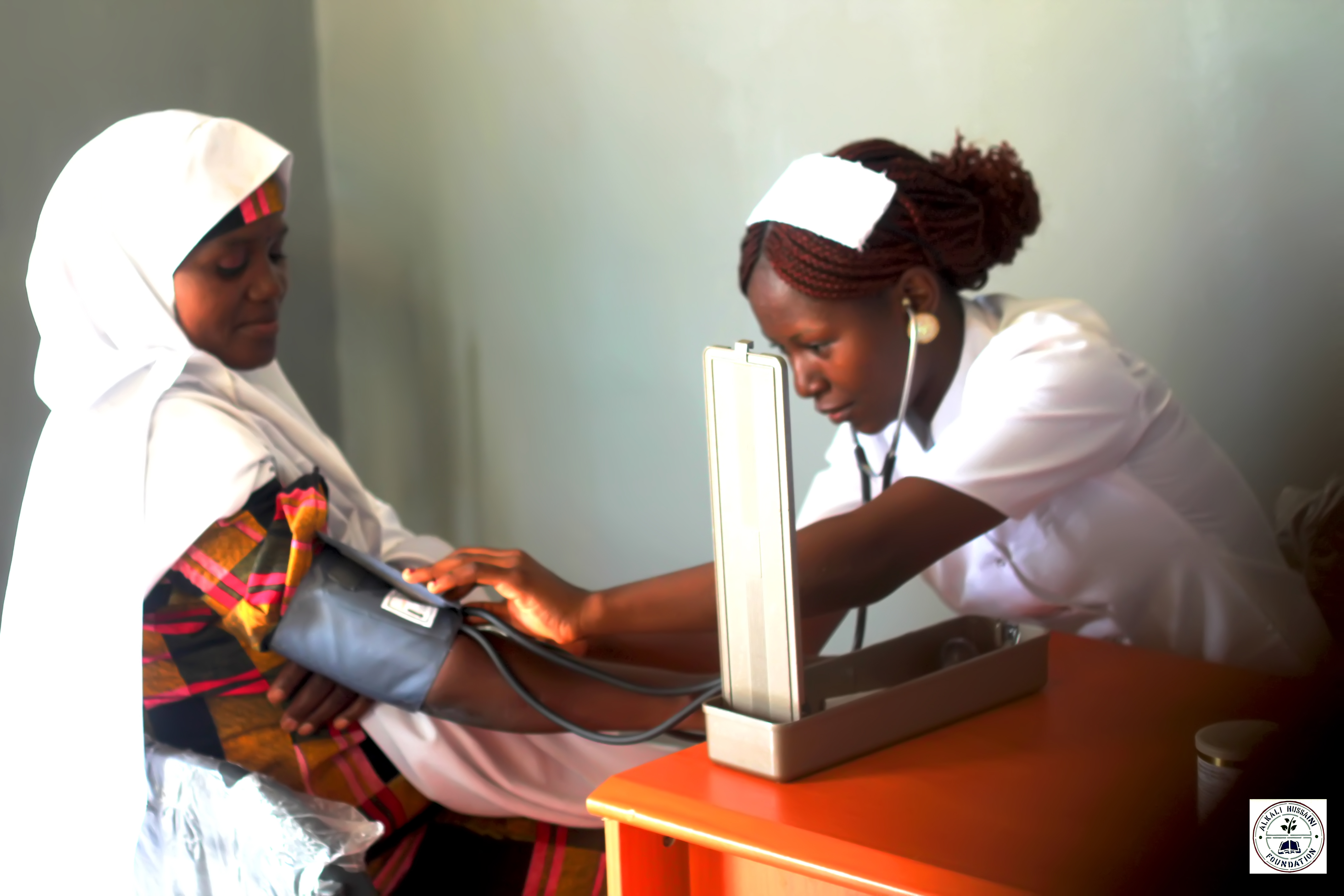 A pregnant woman having her blood pressure checked at Madadi Maternity and Antenatal Health Facility